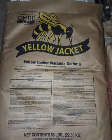 Brown bag with Yellow Jacket branding and product label on a wooden surface