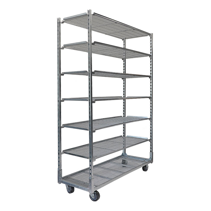 Mobile metal shelving unit with multiple shelves for moving plant starter trays in a nursery.