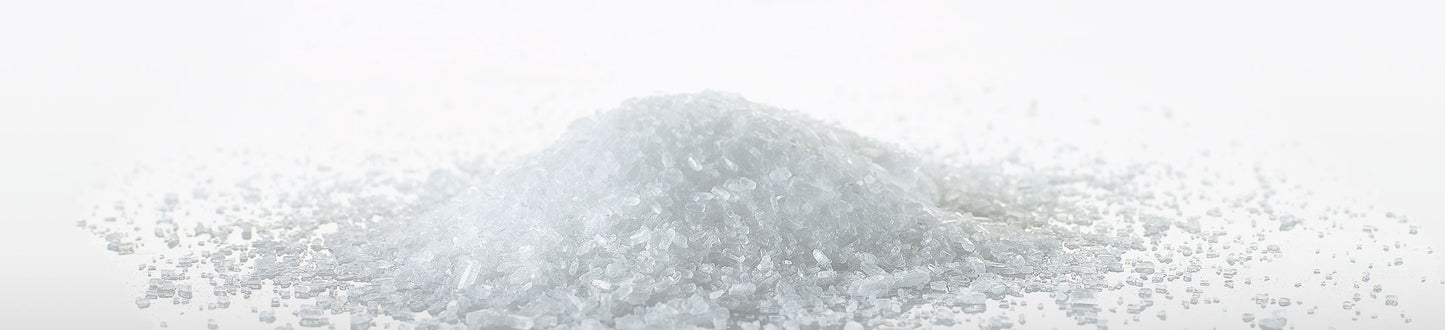 A pile of Magriculture magnesium sulfate heptahydrate rhombic crystals.