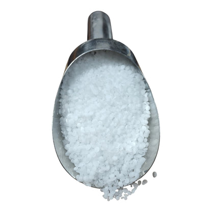 Haifa Magnisal magnesium nitrate prills in a stainless scoop on white background — pure white water-soluble fertilizer granules