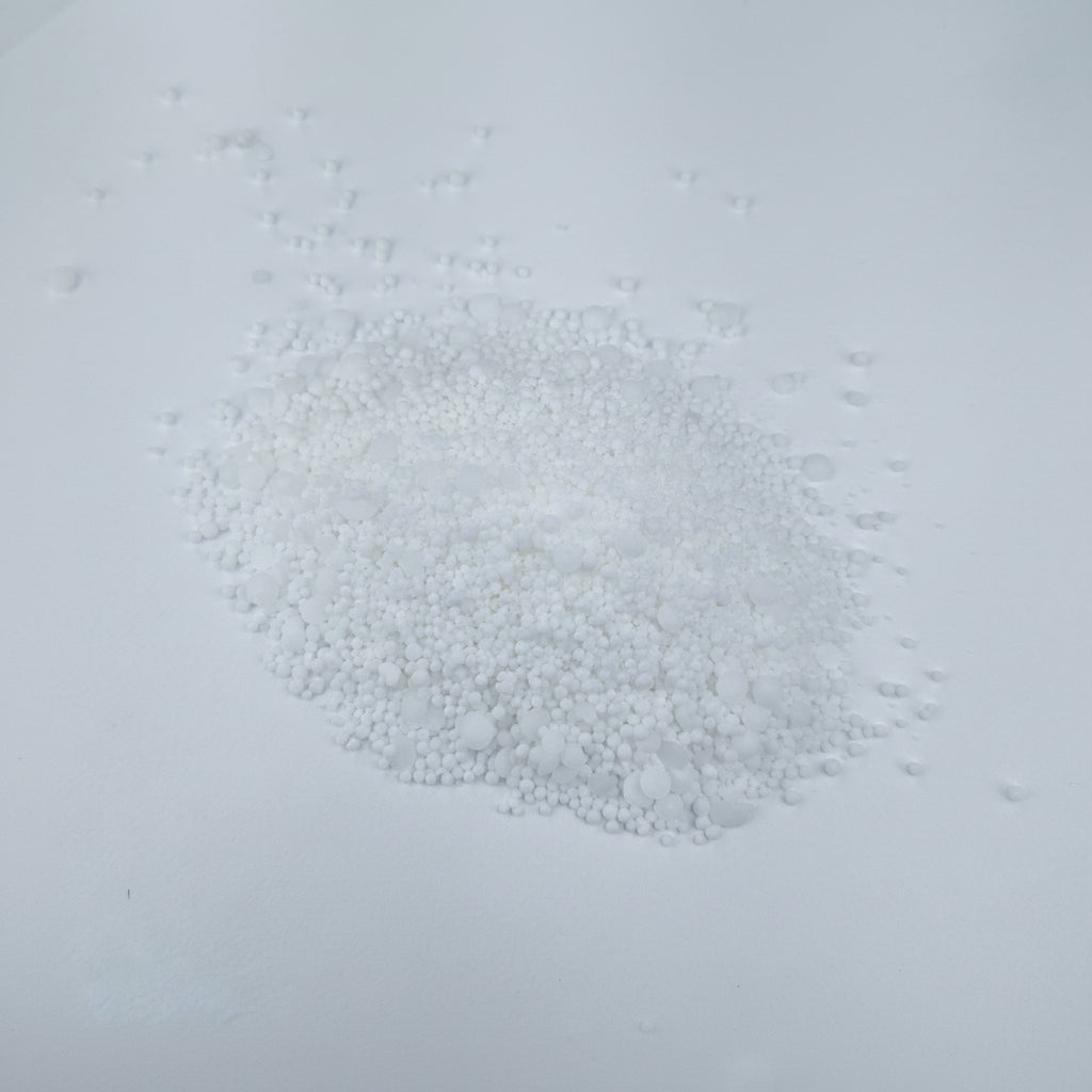 Peters Professional Hydroponic Boost fertilizer small white granules on a light gray background