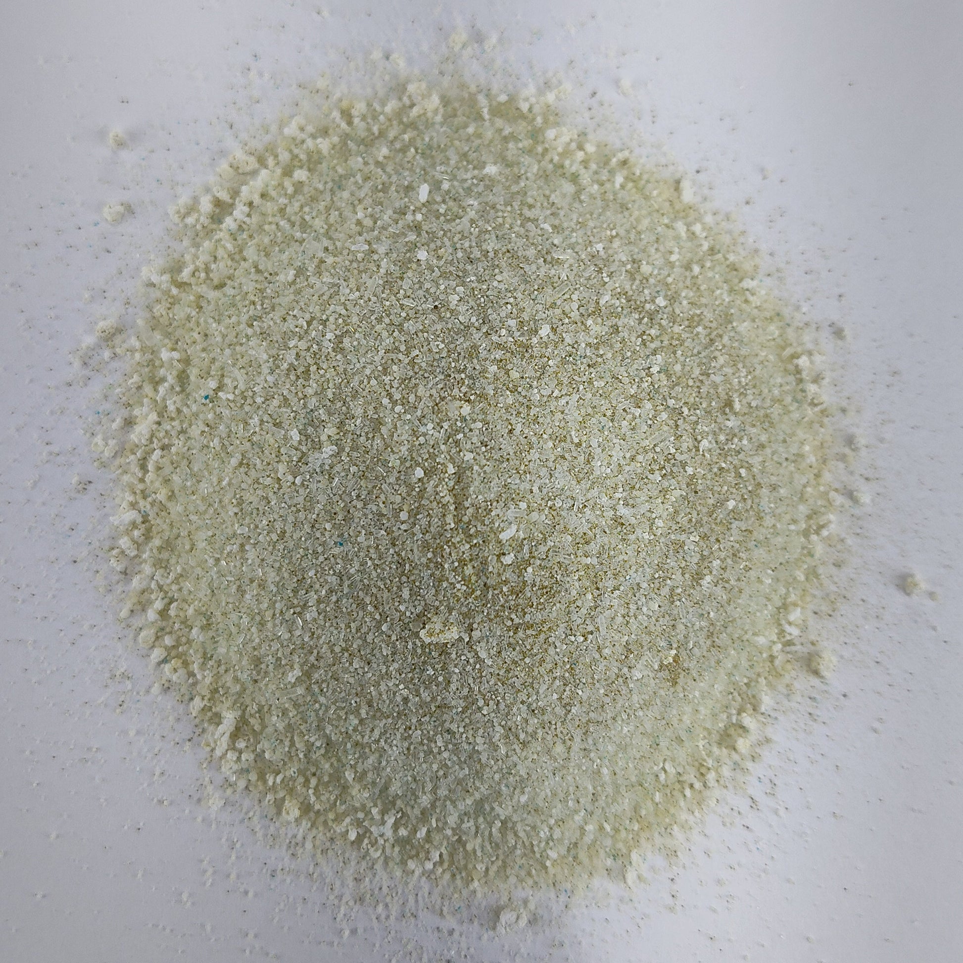 A closeup view of a small pile of MasterBlend 4-18-38 hydroponic tomato fertilizer powder.